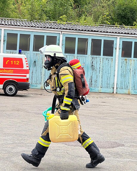Feuerwehrmann mit Schaummittelkanister